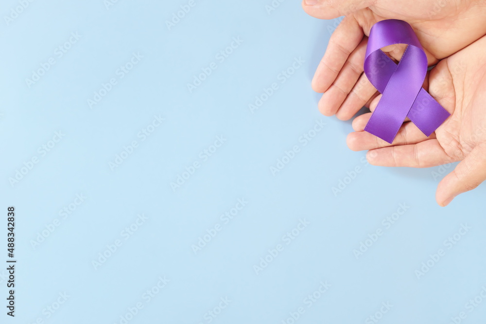 Top view of male hands holding purple ribbon color. Testicular ...