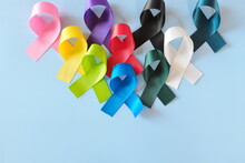 Set Of Colorful Cancer Awareness Ribbons Flat Lay In Blue Background. World Cancer Day Concept.