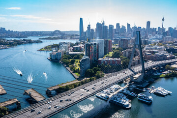 Wall Mural - Aerial drone view of Anzac Bridge looking toward Sydney City and Sydney Harbour on a sunny morning