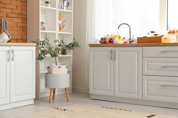 Sticker - Stylish kitchen interior with modern counters and bouquet of flowers in sink