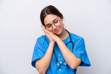 surgeon doctor woman holding tools isolated on white background making sleep gesture in dorable expression