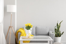 Interior Of Modern Living Room With Tulips In Vase And Easter Rabbit