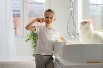 Children brother and sister wash and brush their teeth in the bathroom