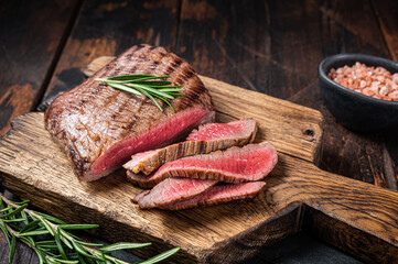 Wall Mural - Barbecue dry aged wagyu Flank Steak on a cutting board. Wooden background. Top view