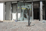 Fototapeta Tęcza - Destroyed automatic sliding glass doors in entrance of building due to vandalism. Looted shopping mall concept.