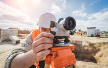 Surveyor Worker With Theodolite Equipment At Construction Site