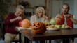 © iaginzburg - Young woman takes a slice of pumpkin from the dinner table and tastes