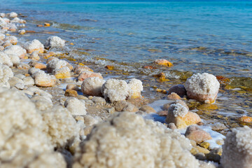 Wall Mural - Close up of salt background. Natural salt. Dead Sea salt mineral natural formations. Salt crystals from Dead sea. View of Dead Sea coastline. Texture of Dead sea. Salty seashore rocks