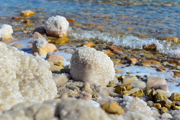 Wall Mural - Close up of salt background. Natural salt. Dead Sea salt mineral natural formations. Salt crystals from Dead sea. View of Dead Sea coastline. Texture of Dead sea. Salty seashore rocks