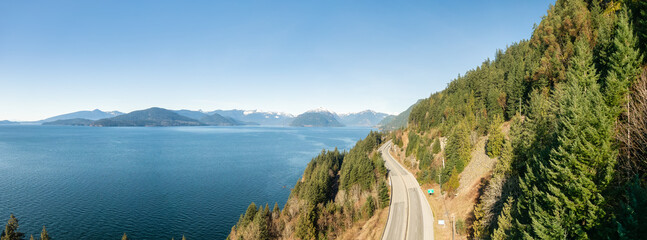 Aerial Panoramic View of Sea to Sky Highway on Pacific Ocean West Coast. Sunny Winter Day. Located in Howe Sound between Vancouver and Squamish, British Columbia, Canada.