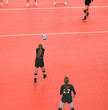 Volleyball player passes the ball from the middle of the court