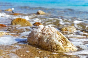 Wall Mural - Close up of salt background. Natural salt. Dead Sea salt mineral natural formations. Salt crystals from Dead sea. View of Dead Sea coastline. Texture of Dead sea. Salty seashore rocks