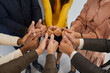 © Studio Romantic - Teamwork, team, cooperation and success. Hands of successful multiracial business team standing in circle and showing thumbs up. Close up of hands of colleagues demonstrating unity and support.