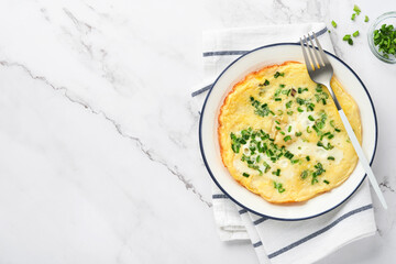 Omelette or frittatas with green onions or young greenery and mozzarella on white marble table background. Healthy food concept. Breakfast. Copy space. Top view. Mock up.