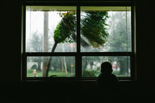 Silhouette Of Boy Watching A Tropical Typhoon Out The Window