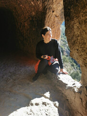 Canvas Print - Rear view of a person resting after hiking in the mountains