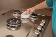 © Francesco  - Young woman cleaning the hob. Household cleaning at home