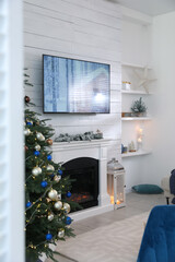 Canvas Print - Stylish living room interior with modern TV, fireplace and Christmas tree