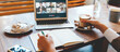 © Alex from the Rock - City cafe workplace. Video call using laptop and camera. Woman has remote team conference