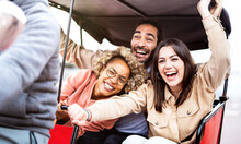 Multiracial Students Cheering On Rickshaw At Travel Location - Life Style Concept With Guys And Girls Having Fun Together - College Mates Riding Around The City After School Vacations - Bright Filter