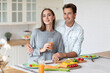 © BestForYou - Romantic young couple in love, man and woman hugging and having a great time together in the kitchen at home. Couple life
