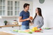 © BestForYou - Young couple in the kitchen with carrot juice. Healthy eating together.