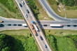 canvas print picture Aerial view of road intersection with fast moving heavy traffic on city streets. Uban transportation during rush hour with many cars and trucks