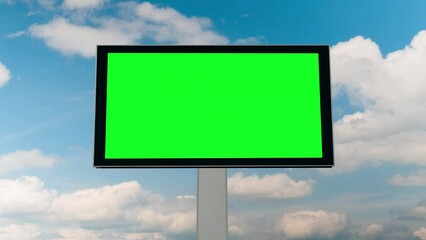 Wall Mural - Blank green billboard or large display and moving white clouds against blue sky - timelapse. Green screen, consumerism, time lapse, template, mock up, copyspace and chroma key concept