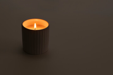 Wall Mural - Closeup of a burning candle in dark background with copy space. Kwanzaa