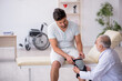© Elnur - Young leg injured patient visiting old male doctor