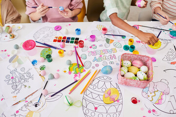 background image of children painting easter eggs and coloring books while enjoying art and craft cl