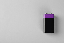 New Nine Volt Battery On Light Grey Background, Top View. Space For Text