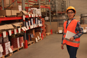 Wall Mural - Woman with tablet working at warehouse. Logistics center