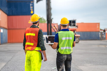 Wall Mural - Professional engineer container cargo foreman team in helmets working standing and using walkie talkie checking stock into container for loading.logistic transport and business industry export