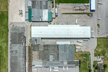 Wall Mural - large logistics hub. trucks stand on parking lot and wait for load and unload goods in warehouse. aerial top view.