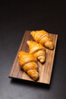 © gexphos - Fresh croissants on a wooden board. Freshly baked in morning.