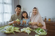 © Odua Images - muslim asian family making ketupat for eid mubarak together