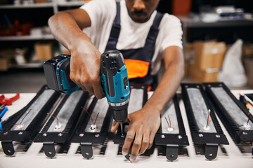 Wall Mural - factory worker using electric screwdriver