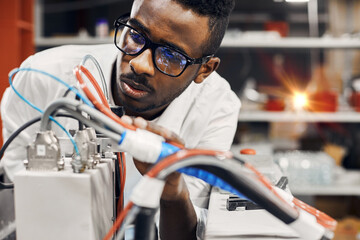 Wall Mural - african engineer programming equipment with tablet at factory