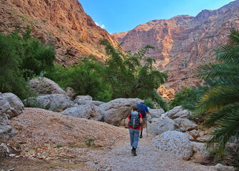 Senior couple hiking along Wadi Shab in Oman