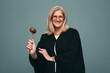 © Jacob Lund - Cheerful mature judge holding up a gavel in a studio