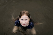 Girl With Brown Hair Swimming In Lake Water