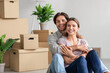 © Prostock-studio - Cheerful excited millennial caucasian male and female in casual hugs, enjoy moving at new flat