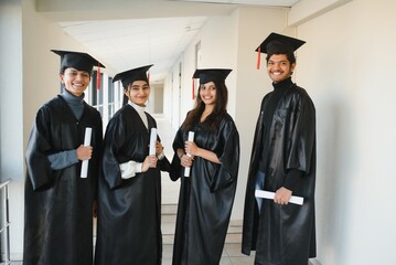 Wall Mural - education, graduation and people concept - group of happy international students.