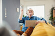 © Westend61 - Happy senior man with eyes closed enjoying music through wireless headphones in living room