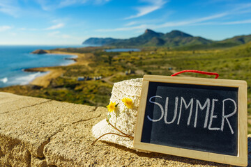 Wall Mural - Black board with word summer against sea coast