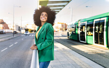 Smiling Commuter Standing At Tram Station