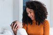 © Westend61 - Happy mother looking at son in living room