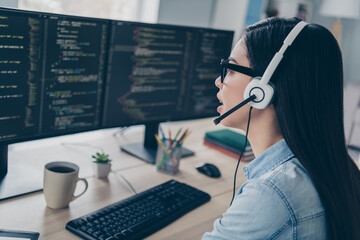 Profile side photo of lady assistant answer complain server platform debugging wear headphones glasses sit desk in modern workplace