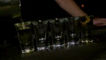 Close-up Of A Barman Pouring Mix In Shooter Glasses